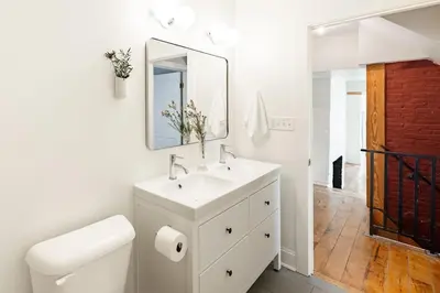 a white bathroom with a sink and a mirror at Soaring 2BR Parkside Loft Walkable to it All in Cincinnati
