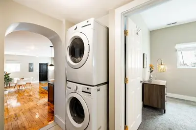 a laundry room with a washer and dryer at Explore OTR from a Parkside Condo - Walk to ALL in Cincinnati
