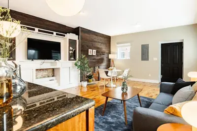 a living room with a couch and a table at Explore OTR from a Parkside Condo - Walk to ALL in Cincinnati