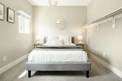 a bedroom with a large bed with two lamps at Explore OTR from a Parkside Condo - Walk to ALL in Cincinnati