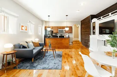 a living room with a couch and a table at Explore OTR from a Parkside Condo - Walk to ALL in Cincinnati