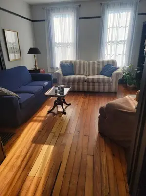 a living room with two couches and a coffee table at 1895 meets 2023 Townhouse. in Hamilton