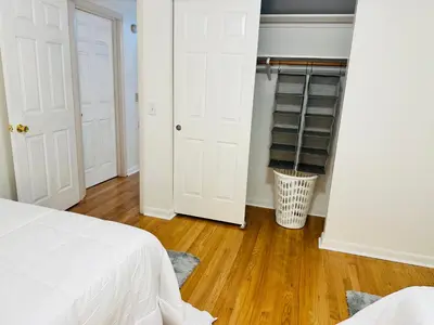 a bedroom with white doors and a wooden floor at Sunshine Palace in West Chester