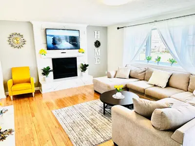 a living room with a couch and a fireplace at Sunshine Palace in West Chester