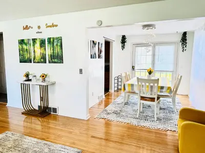 a dining room and living room with a table and chairs at Sunshine Palace in West Chester