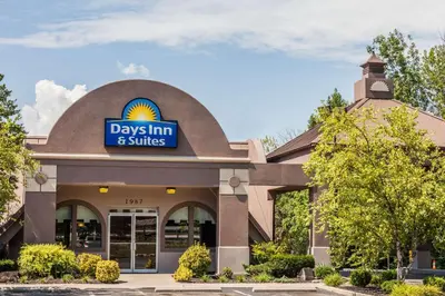 a day inn and suites building with a sign on it at Days Inn & Suites by Wyndham Lexington in Lexington