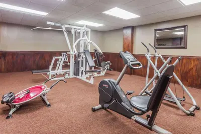 a gym with several exercise equipment in a room at Days Inn & Suites by Wyndham Lexington in Lexington