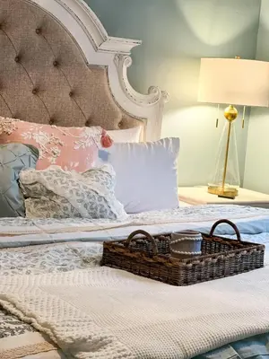 a bed with a basket on it with a lamp at Guesthouse 214 at Guesthouse Lodging in Millersburg