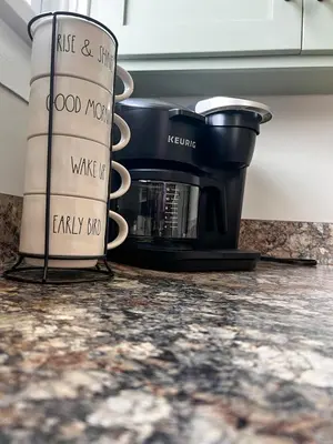a coffee pot sitting on a counter with coffee cups at Guesthouse 214 at Guesthouse Lodging in Millersburg
