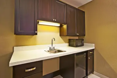 a kitchen with a sink and a microwave at Holiday Inn Express & Suites Springfield by IHG in Springfield