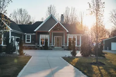 a house with the sun setting behind it at FeralWoods Private Estate With Hot Tub in Columbia Station