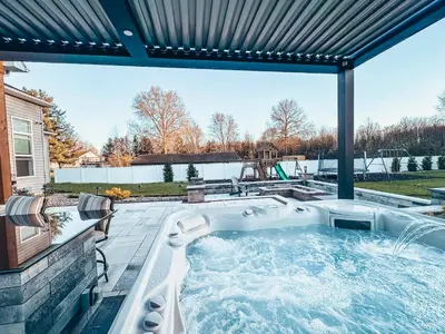 a hot tub on the patio of a house at FeralWoods Private Estate With Hot Tub in Columbia Station