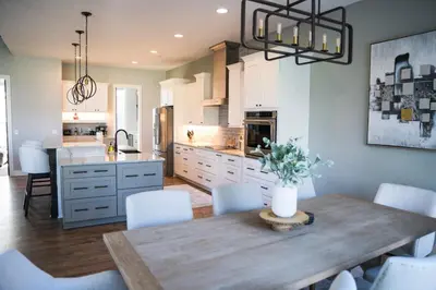 a kitchen with a wooden table and a dining room at FeralWoods Private Estate With Hot Tub in Columbia Station