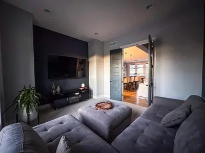 a living room with a couch and a table at FeralWoods Private Estate With Hot Tub in Columbia Station