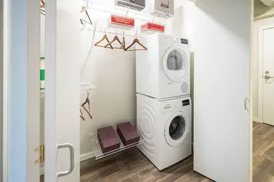 a laundry room with a washer and dryer at Downtown Chic New Studio Oasis Close to it All in Cleveland