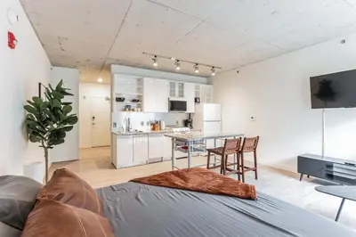 a living room with a couch and a table at Downtown Chic New Studio Oasis Close to it All in Cleveland