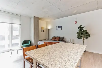 a room with a table and chairs and a bed at Downtown Chic New Studio Oasis Close to it All in Cleveland