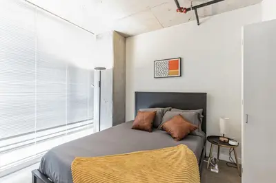 a bedroom with a bed and a large window at DT Delight Downtown Living Two-Bedroom Endless Access in Cleveland