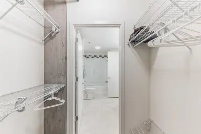 a room with a toilet and a walk in closet at DT Delight Downtown Living 2bd2ba Endless Access in Cleveland