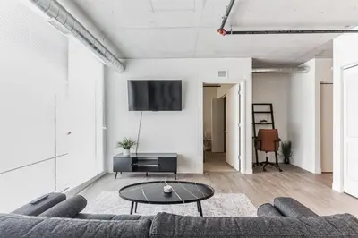 a living room with a couch and a table at DT Delight Downtown Living 2bd2ba Endless Access in Cleveland
