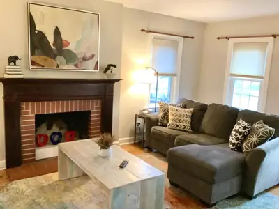 a living room with a couch and a fireplace at Cute 2 Bedroom Home - Huge backyard, near downtown! in Cleveland
