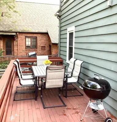 a patio with a grill and a table and chairs at Cute 2 Bedroom Home - Huge backyard, near downtown! in Cleveland