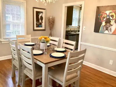 a dining room with a table and chairs at Cute 2 Bedroom Home - Huge backyard, near downtown! in Cleveland