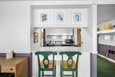 two green chairs sitting at a kitchen counter at The Fountain Inn in Lakeside