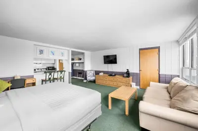 a hotel room with a bed and a couch at The Fountain Inn in Lakeside