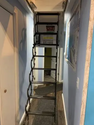 a metal staircase in a hallway with a room at Rye Beach Retreat in Huron