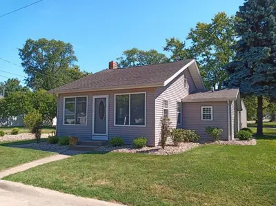 a small house with a grassy yard at Rye Beach Retreat in Huron