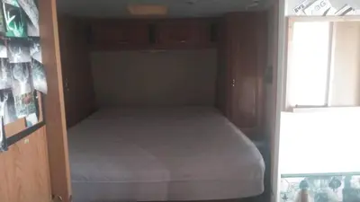 a small bedroom with a bed in a closet at Two Creeks Camp in Athens