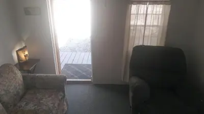 a living room with a couch and a chair and a window at Two Creeks Camp in Athens