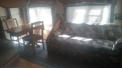 a living room with a couch and a table at Two Creeks Camp in Athens