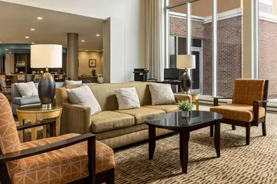 a living room with a couch and a table at Wyndham Avon in Avon Center