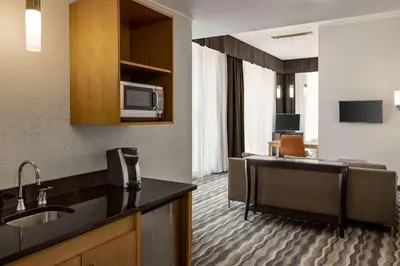 a hotel room with a kitchen and a living room at Wyndham Avon in Avon Center