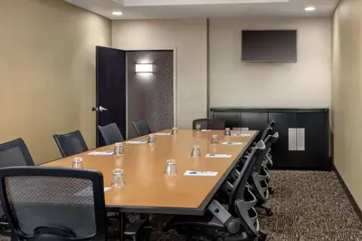 a conference room with a long table and chairs at Wyndham Avon in Avon Center