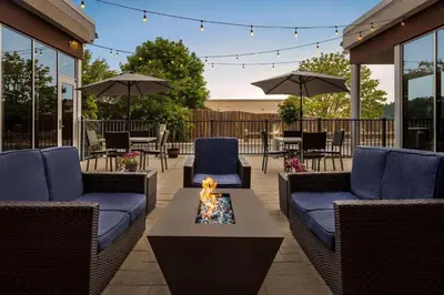 a patio with wicker chairs and a fire pit at Wyndham Avon in Avon Center