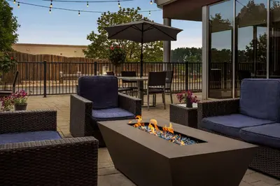 a patio with two chairs and a fire pit at Wyndham Avon in Avon Center