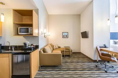 a hotel room with a couch and a kitchen at Wyndham Avon in Avon Center
