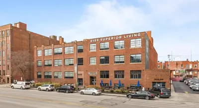 a large brick building with cars parked in a parking lot at 2125 Superior Living in Cleveland