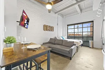 a living room with a couch and a bed at 2125 Superior Living in Cleveland