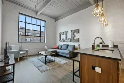 a kitchen and living room with a couch and a table at 2125 Superior Living in Cleveland