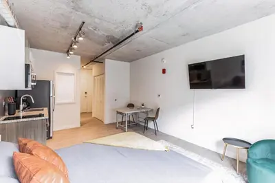 a living room with a couch and a table at Urban Elegance Studio Oasis Prime Location in Cleveland
