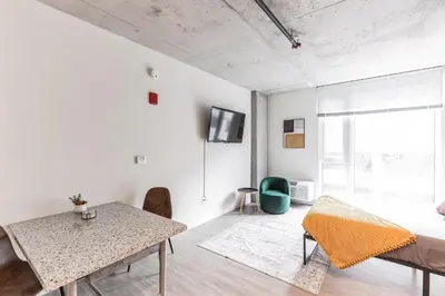 a white living room with a table and chairs at Urban Elegance Studio Oasis Prime Location in Cleveland