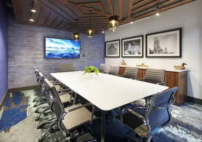 a conference room with a large white table and chairs at Sleek downtown Cleveland apartment in Cleveland