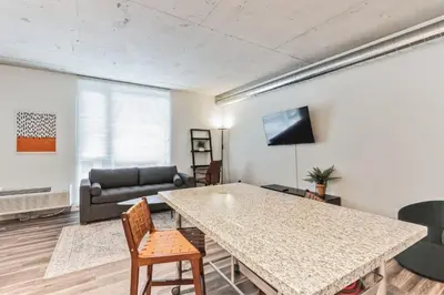 a living room with a table and a couch at Sleek downtown Cleveland apartment in Cleveland