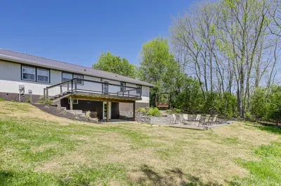 a house with a large yard in front of it at Dry Ridge Farmhouse with Hot Tub and Game Room! in Dry Ridge