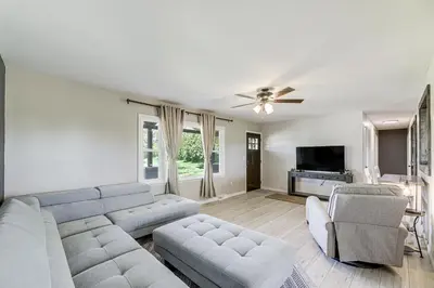 a living room with a couch and a tv at Dry Ridge Farmhouse with Hot Tub and Game Room! in Dry Ridge