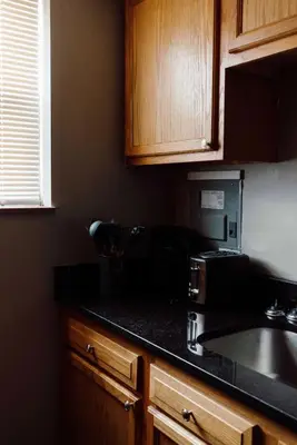 a kitchen with a black counter top and a microwave at Maple Heights Serenity Libby Unit 2 in Maple Heights
